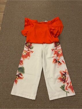Orange top and floral print jeans, size 10